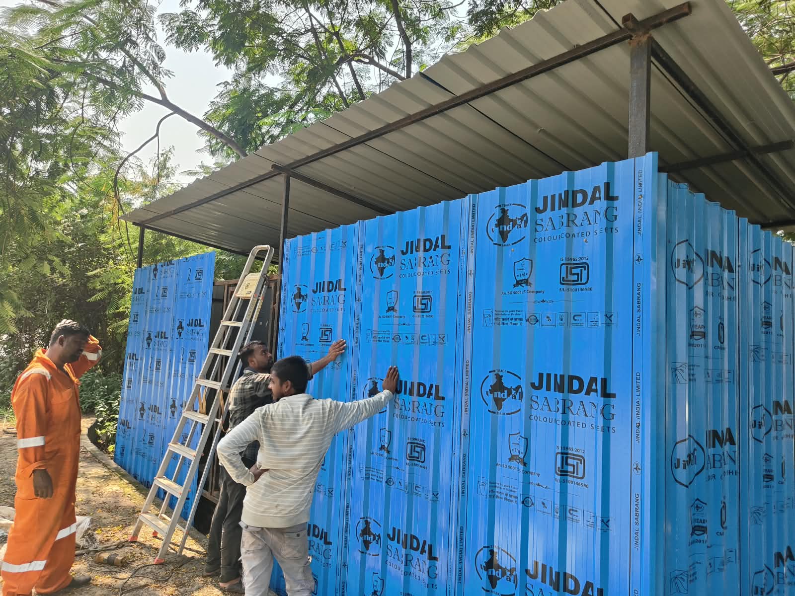 Cladding work beside the equipment shelter